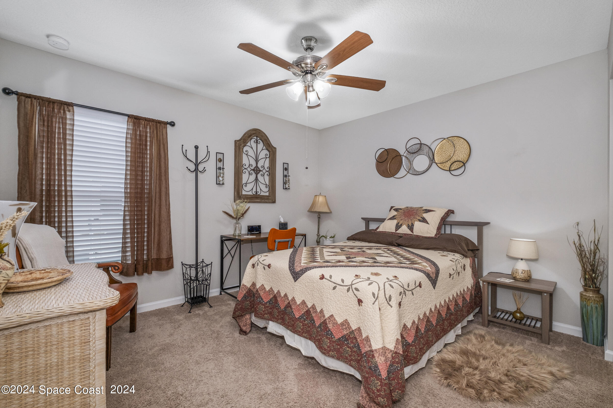 1011 Grapefruit Road Southeast Palm Bay, FL 32909 - Photo 20 of 42 a bedroom with a bed and a chandelier