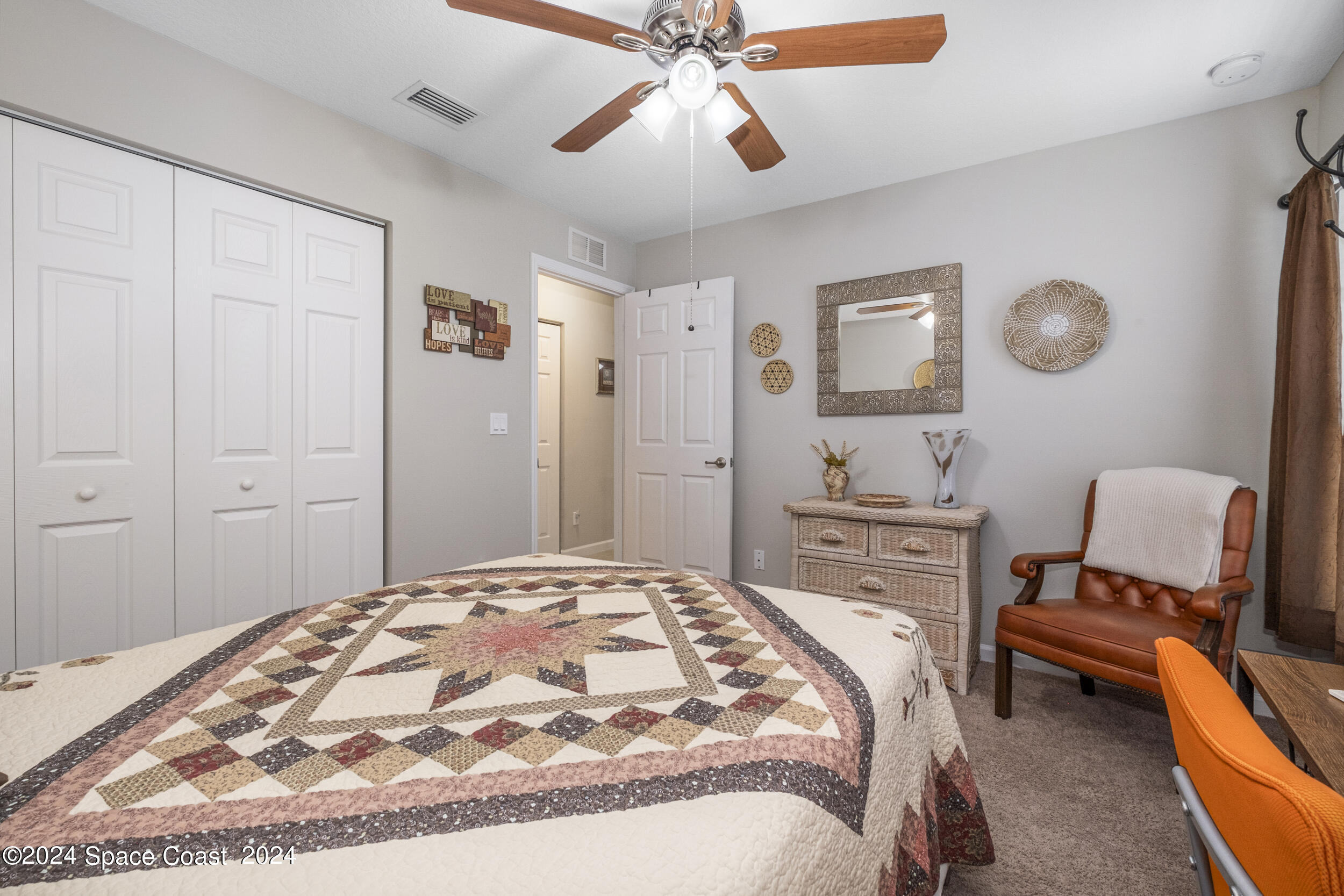 1011 Grapefruit Road Southeast Palm Bay, FL 32909 - Photo 21 of 42 a bedroom with a bed and a chandelier