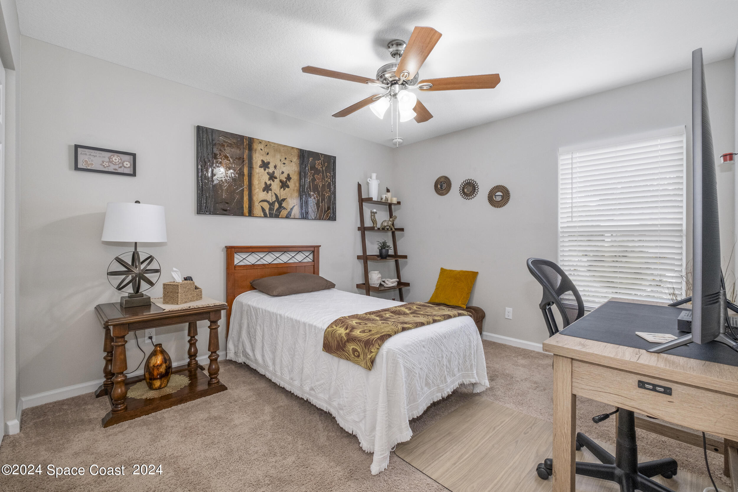 1011 Grapefruit Road Southeast Palm Bay, FL 32909 - Photo 22 of 42 a bedroom with a bed a couch and a window