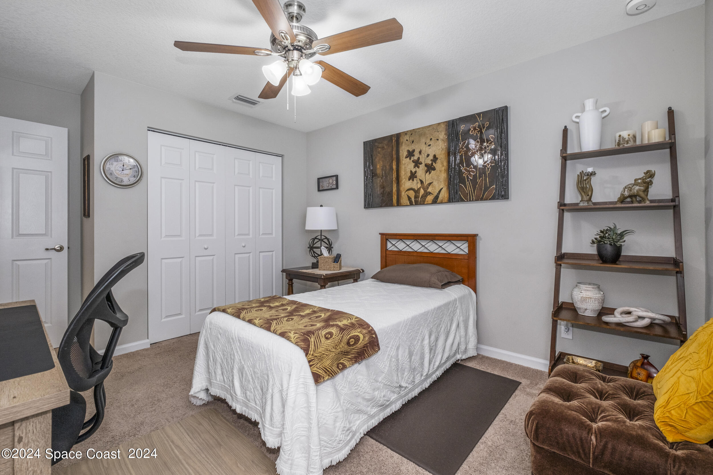 1011 Grapefruit Road Southeast Palm Bay, FL 32909 - Photo 23 of 42 a bedroom with a bed and a chandelier