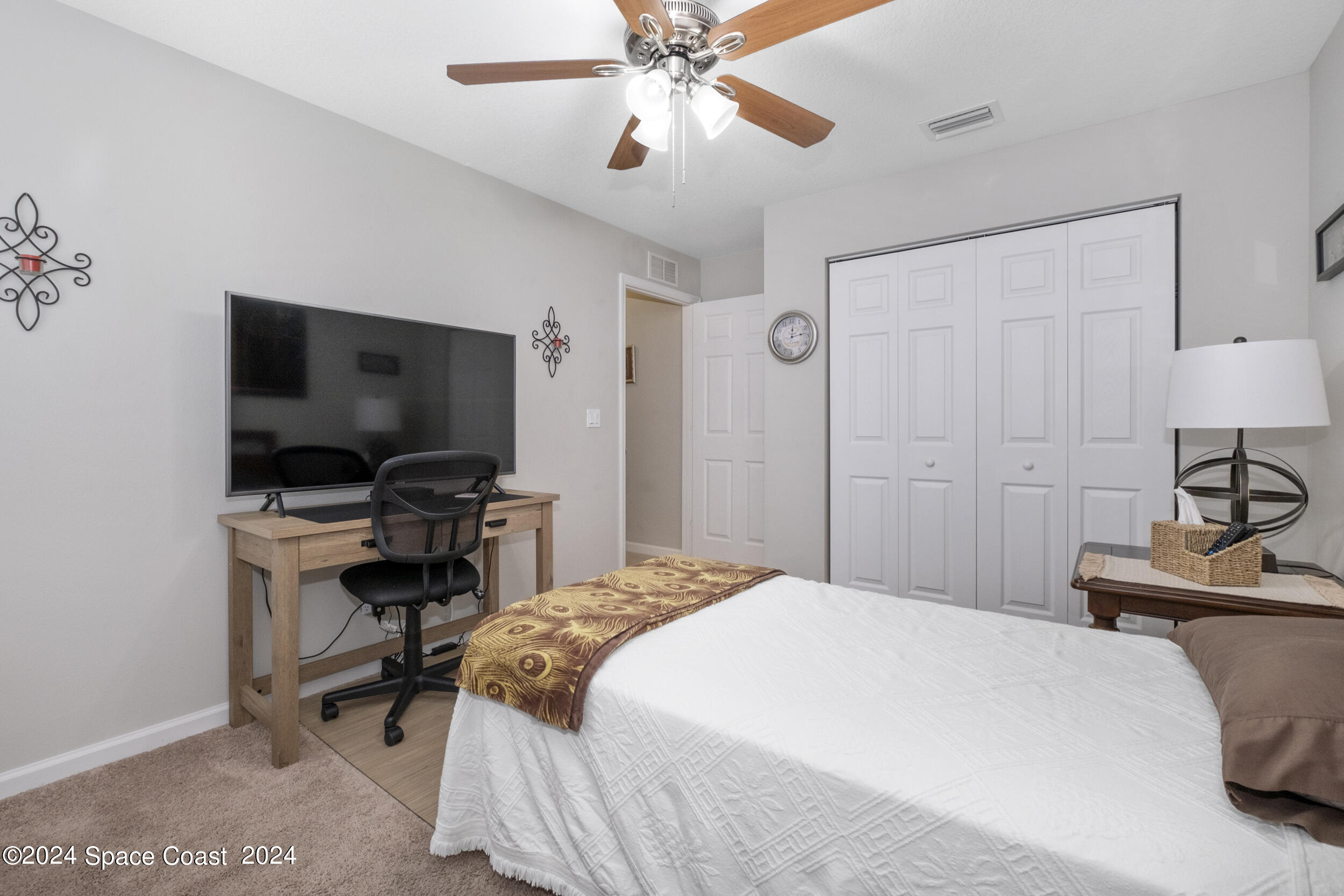 1011 Grapefruit Road Southeast Palm Bay, FL 32909 - Photo 24 of 42 a bedroom with a bed and a flat screen tv