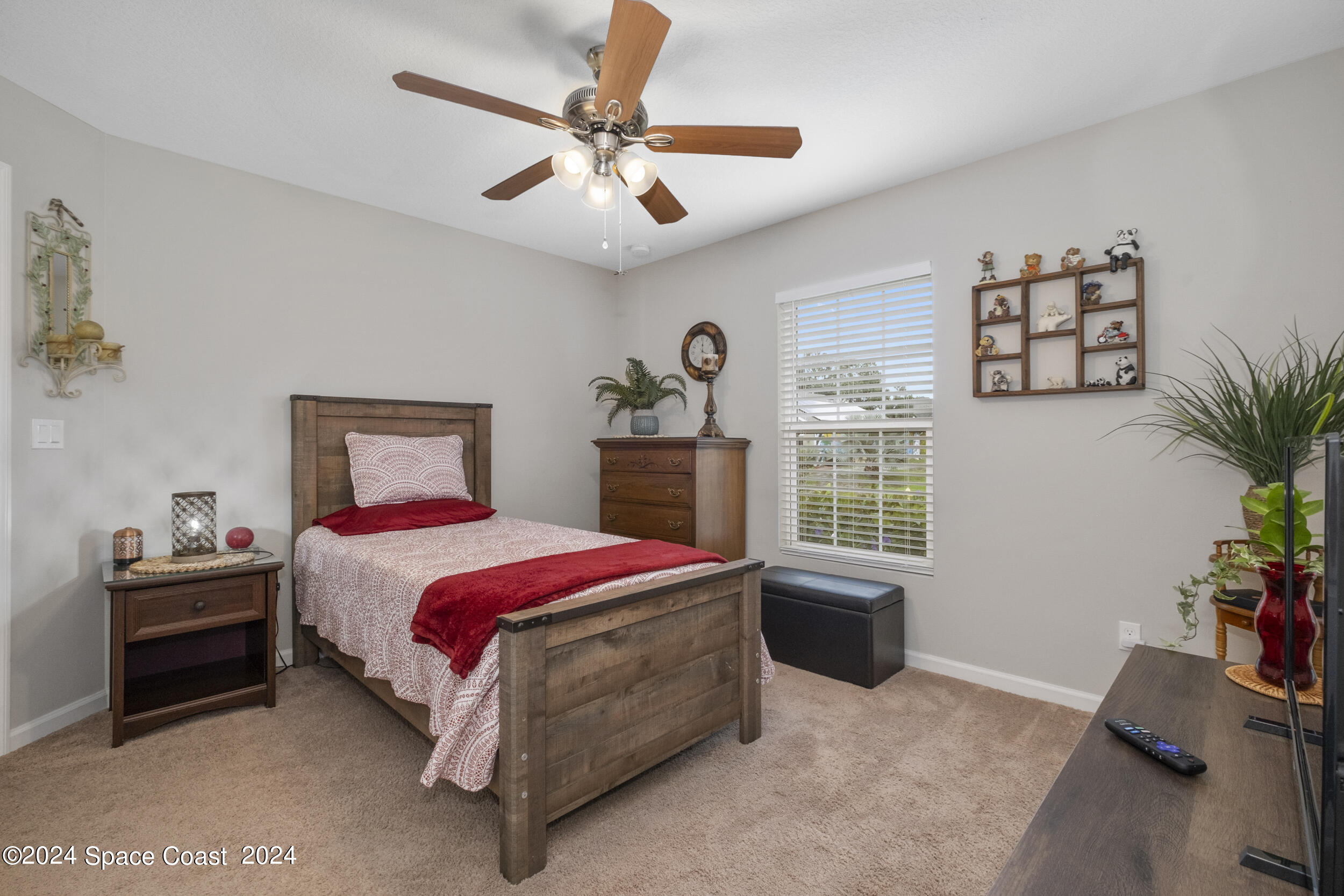 1011 Grapefruit Road Southeast Palm Bay, FL 32909 - Photo 26 of 42 a bedroom with a bed and a chandelier