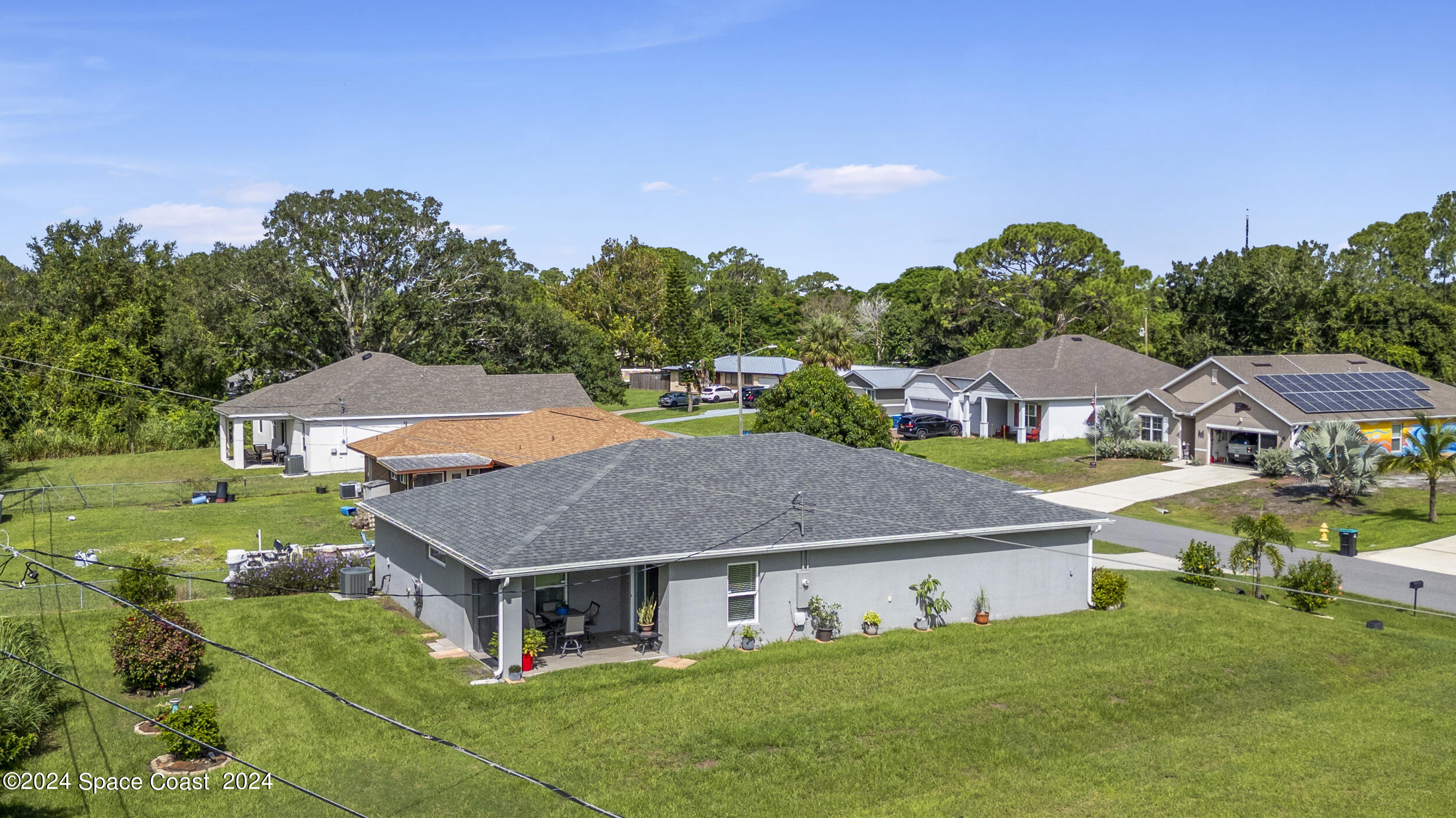 1011 Grapefruit Road Southeast Palm Bay, FL 32909 - Photo 34 of 42 a aerial view of a house with a big yard