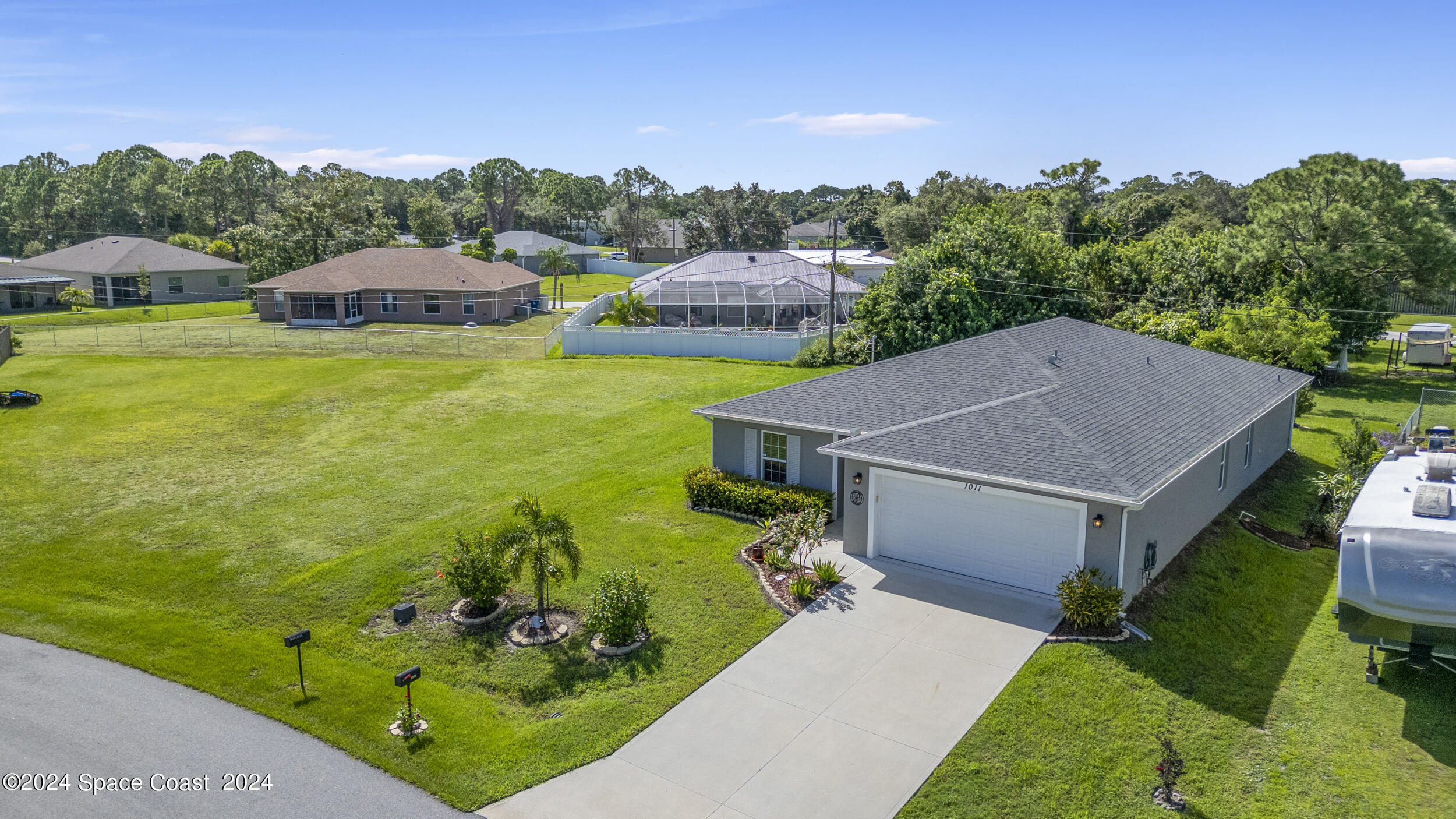 1011 Grapefruit Road Southeast Palm Bay, FL 32909 - Photo 41 of 42 a aerial view of a house with big yard