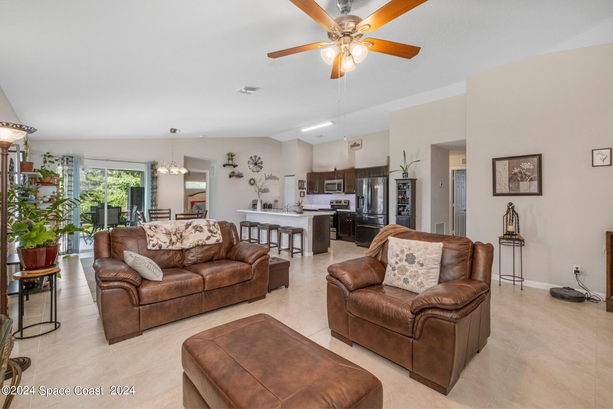 1011 Grapefruit Road Southeast Palm Bay, FL 32909 - Photo 6 of 42 a living room with furniture kitchen view and a large window