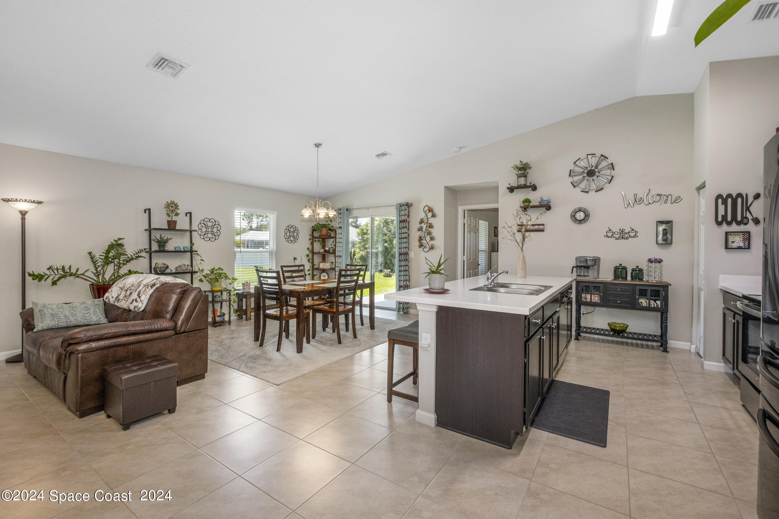 1011 Grapefruit Road Southeast Palm Bay, FL 32909 - Photo 7 of 42 a living room with furniture and a large window