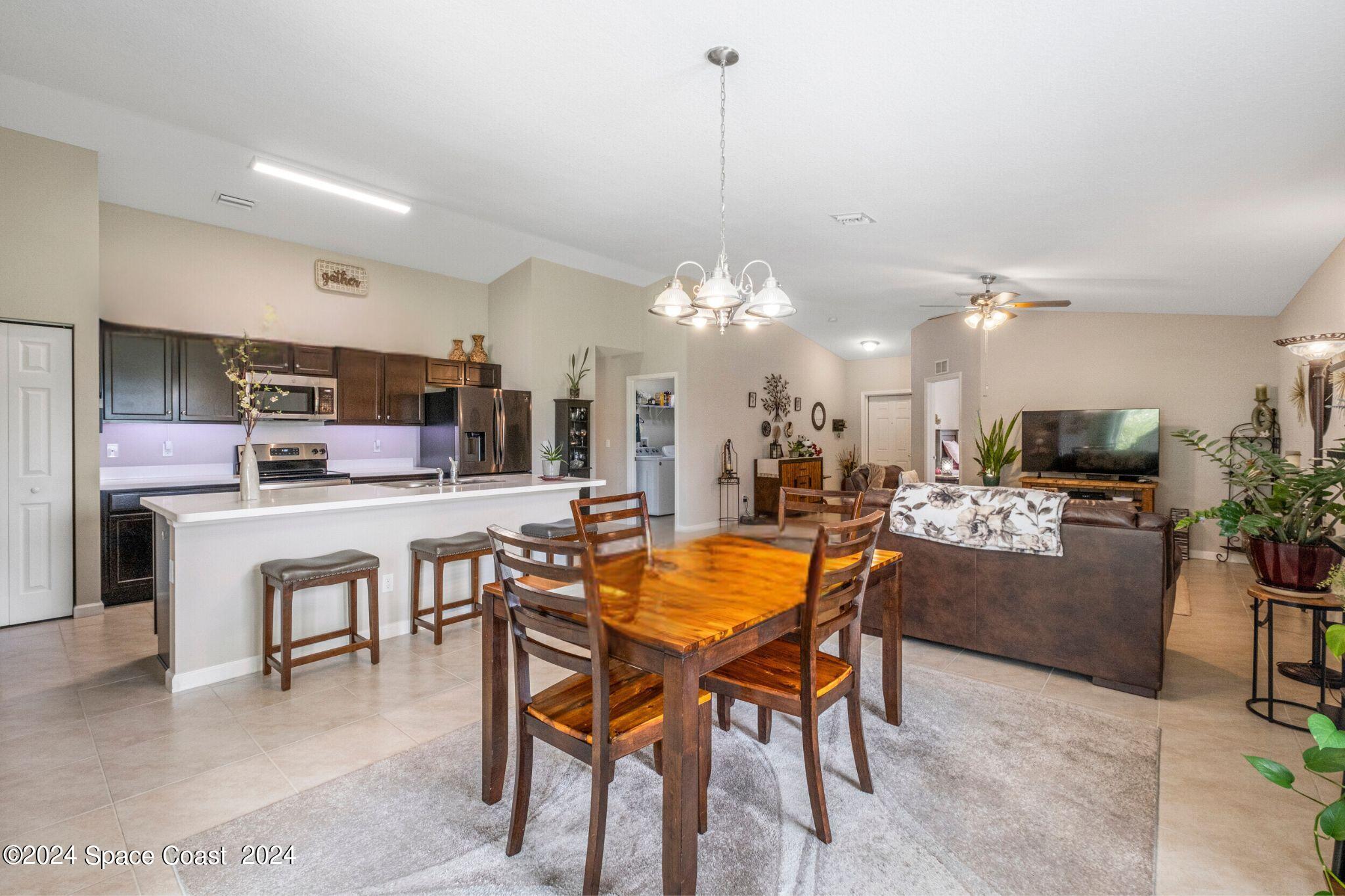 1011 Grapefruit Road Southeast Palm Bay, FL 32909 - Photo 8 of 42 a dining area with a table and chairs in it