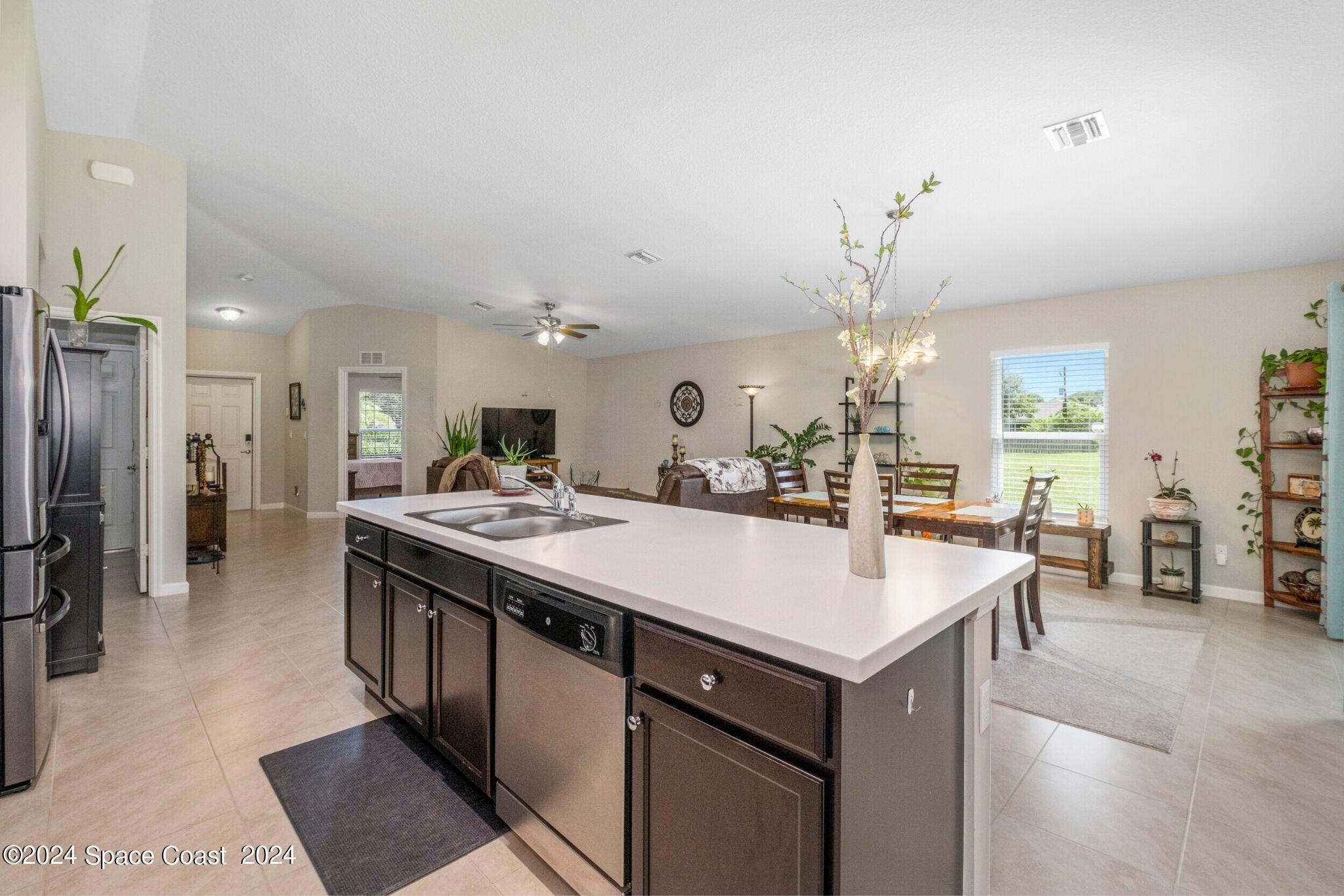 1011 Grapefruit Road Southeast Palm Bay, FL 32909 - Photo 9 of 42 a large kitchen with a counter top space and stainless steel appliances