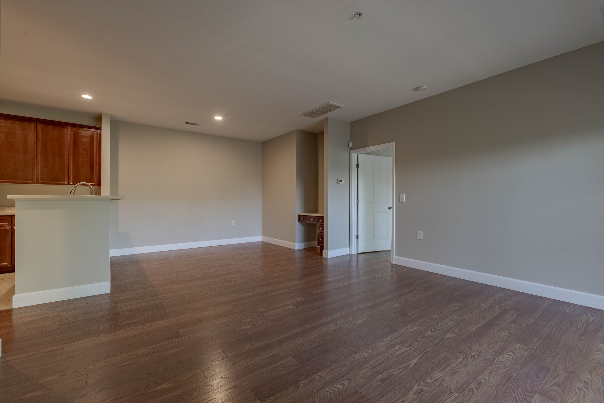 7321 Althorp Way, Unit R5 Nashville, TN 37211 - Photo 13 of 29 a view of an empty room with wooden floor and staircase