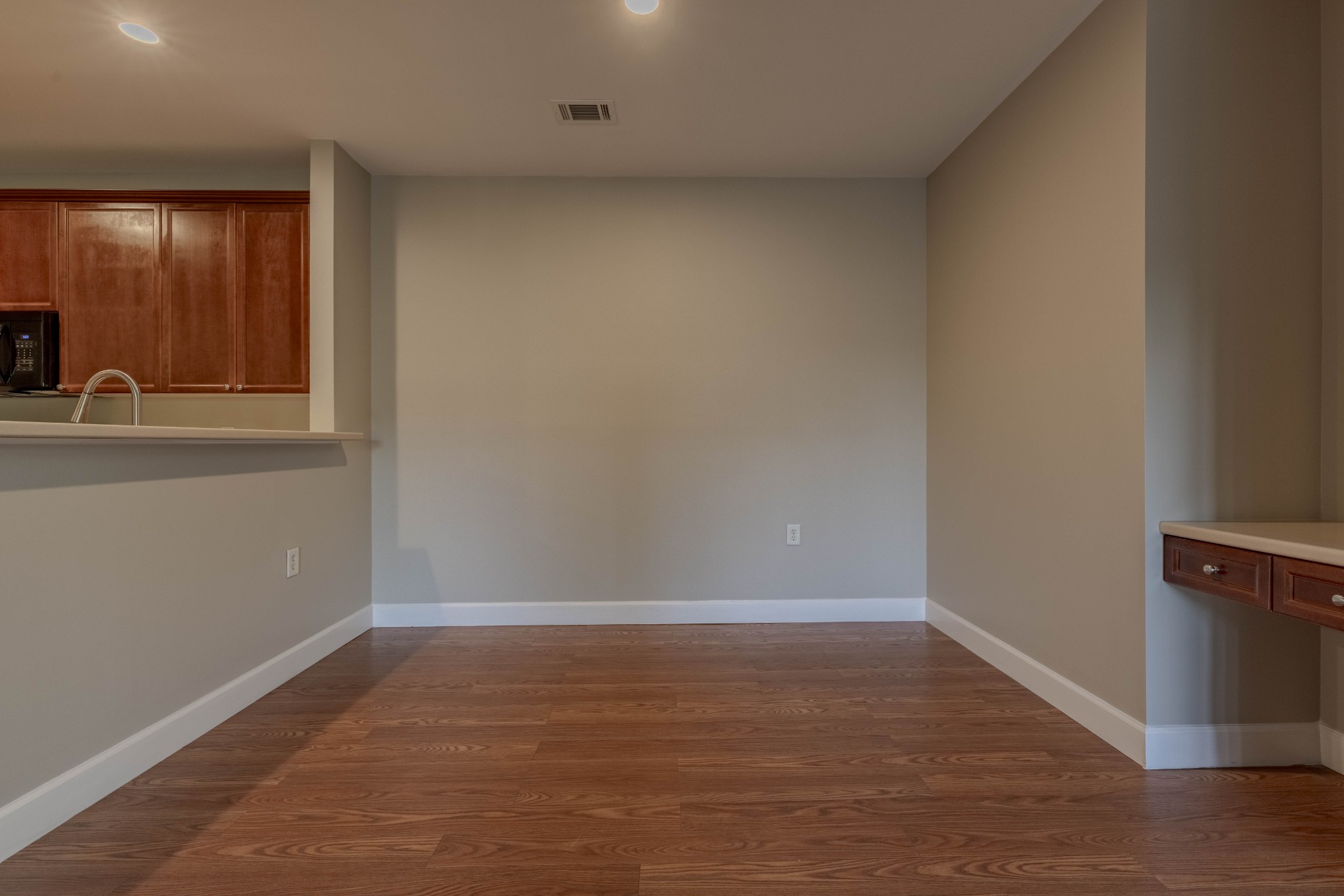 7321 Althorp Way, Unit R5 Nashville, TN 37211 - Photo 14 of 29 a view of an empty room with wooden floor and a window
