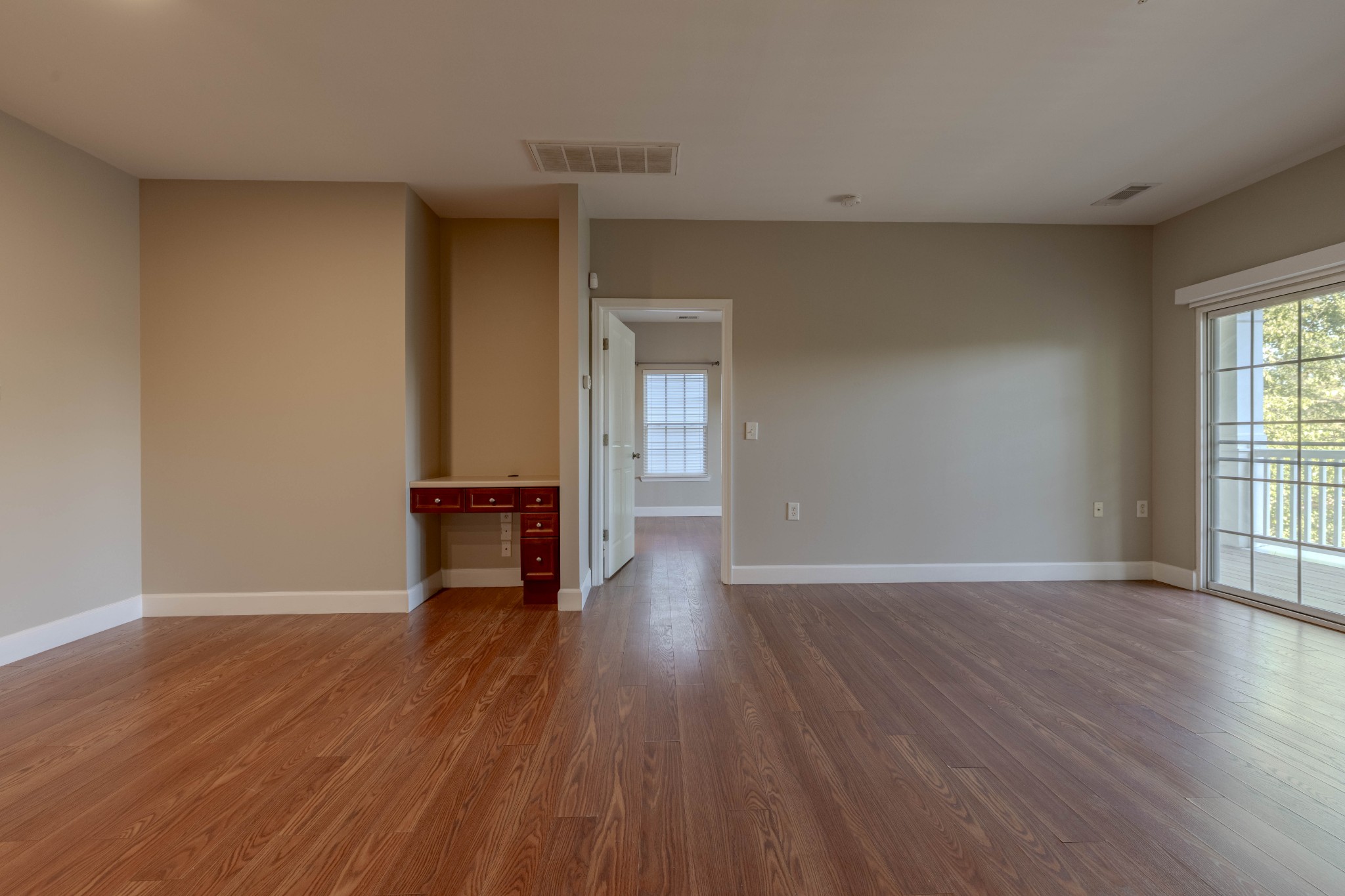 7321 Althorp Way, Unit R5 Nashville, TN 37211 - Photo 9 of 29 a view of an empty room with wooden floor and a window