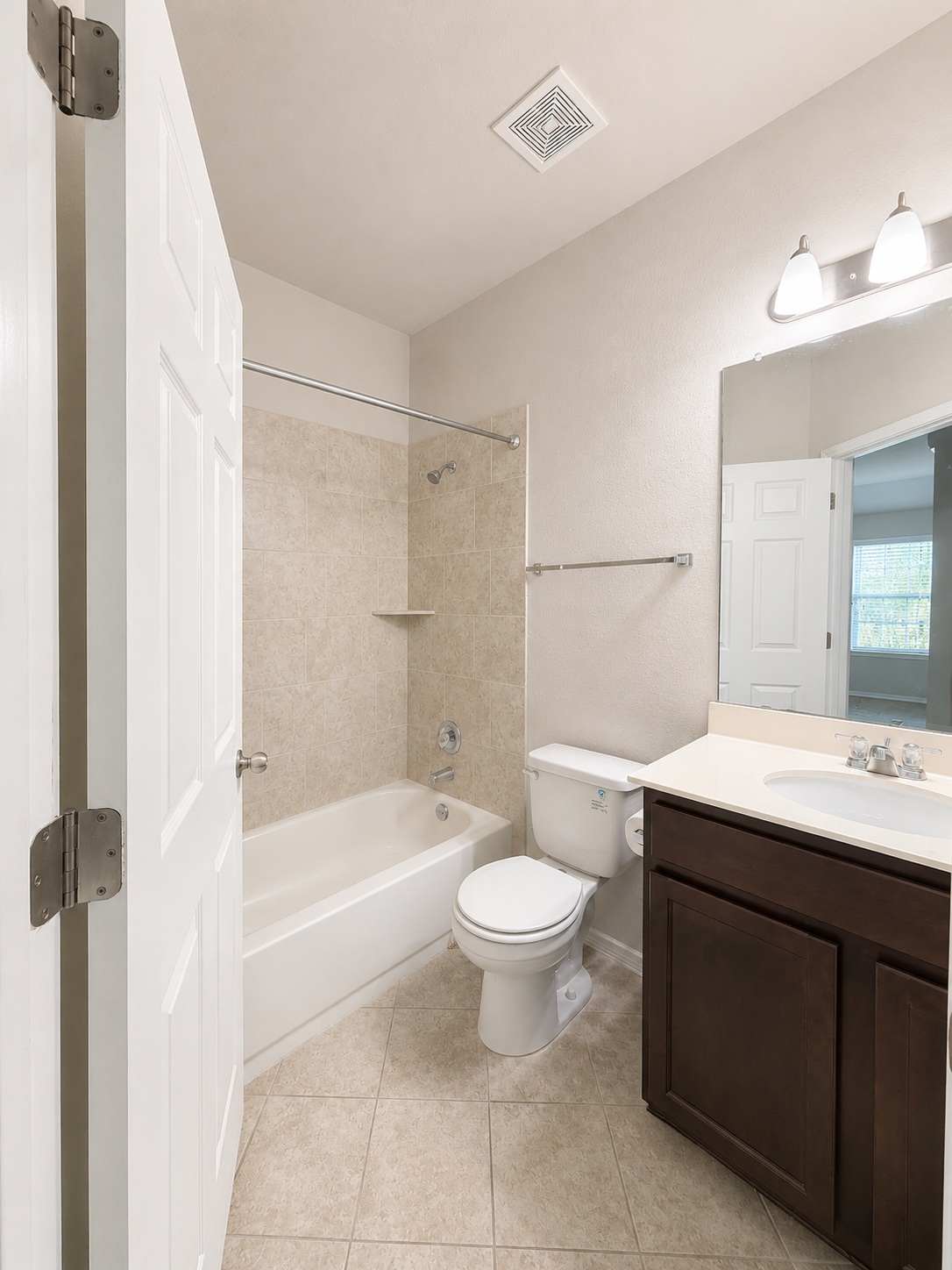 187 Limerick Road Buda, TX 78610 - Photo 13 of 18 A pristine bathroom featuring a shower-tub combination and a vanity with abundant counter space.