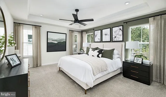 a large bed sitting in a bedroom next to a window