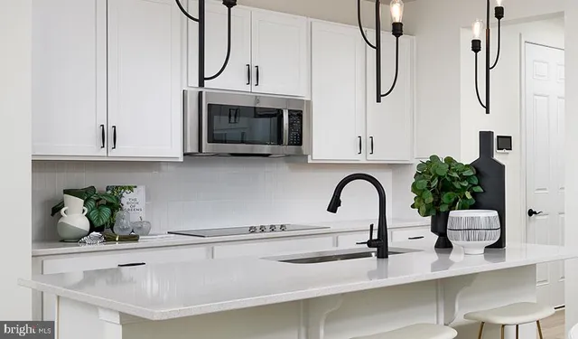 a kitchen with stainless steel appliances granite countertop a sink and cabinets