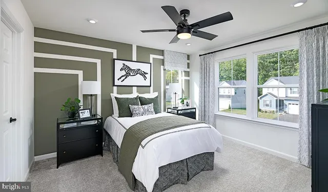 a bedroom with a large bed and a large window