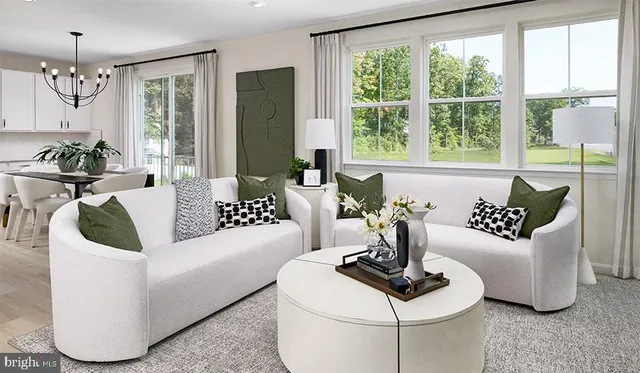 a living room with fireplace furniture and a large window