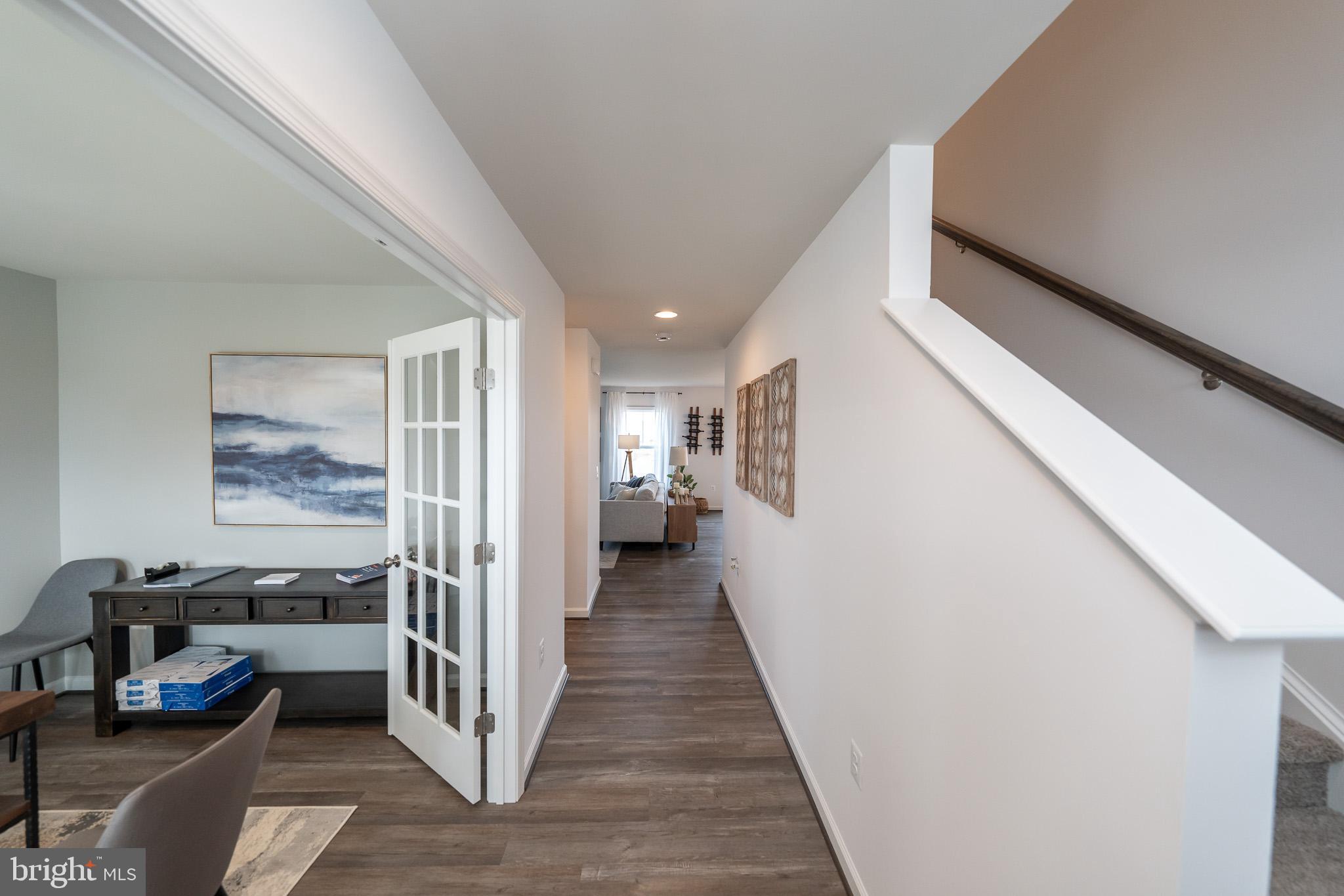 121 Indian Hills Road Locust Grove, VA 22508 - Photo 2 of 26 a view of a hallway to a livingroom with furniture and white walls