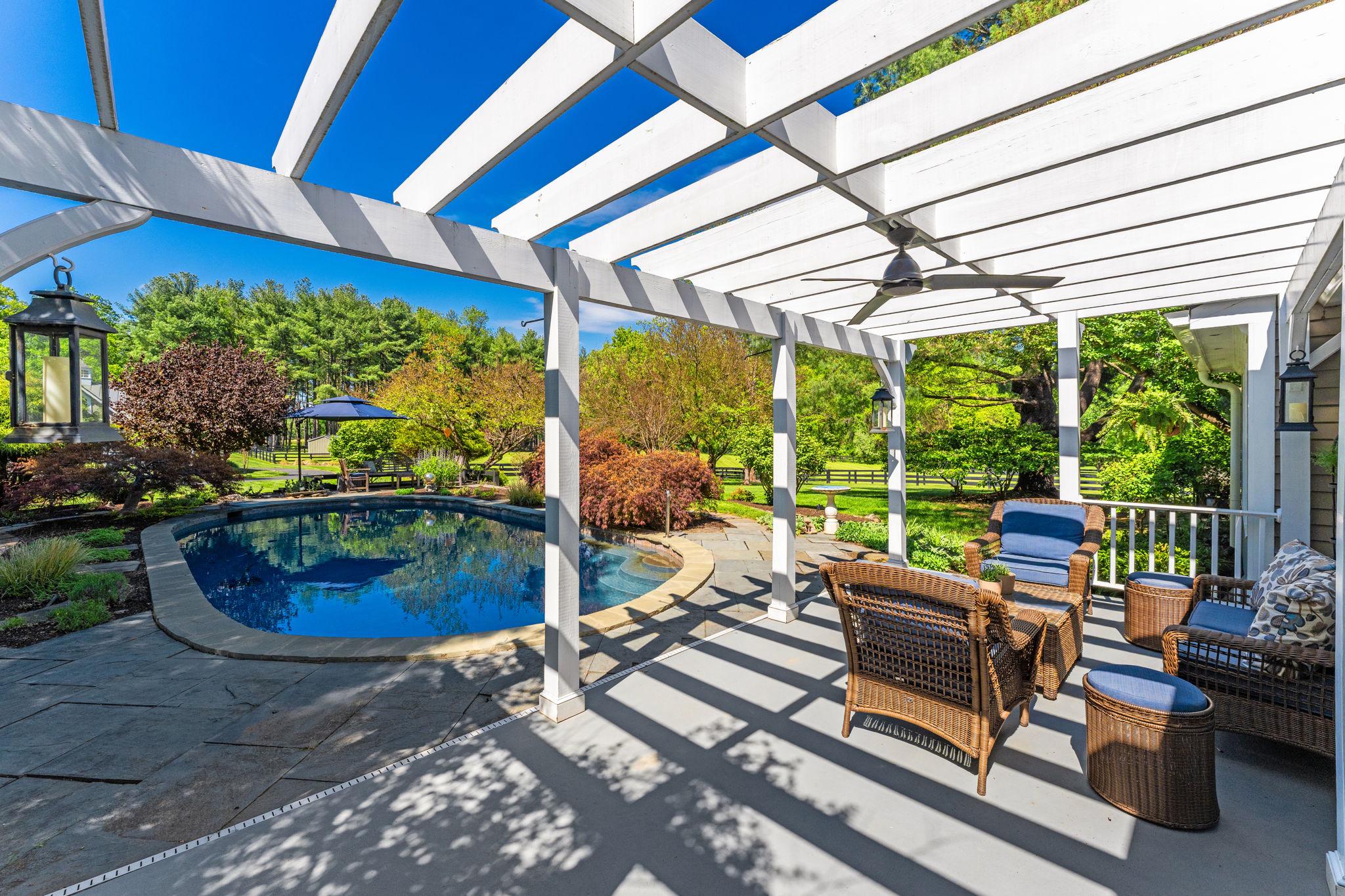 23559 Parsons Road Middleburg, VA 20117 - Photo 53 of 75 a view of a patio with table and chairs potted plants and floor to ceiling window