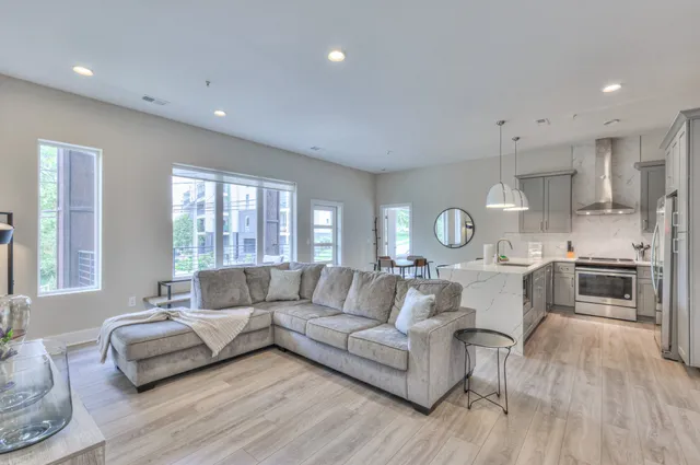 a living room with furniture and a wooden floor