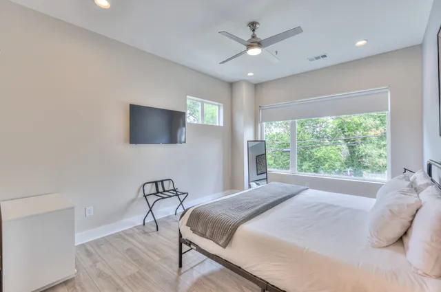 a bedroom with a bed and a tv