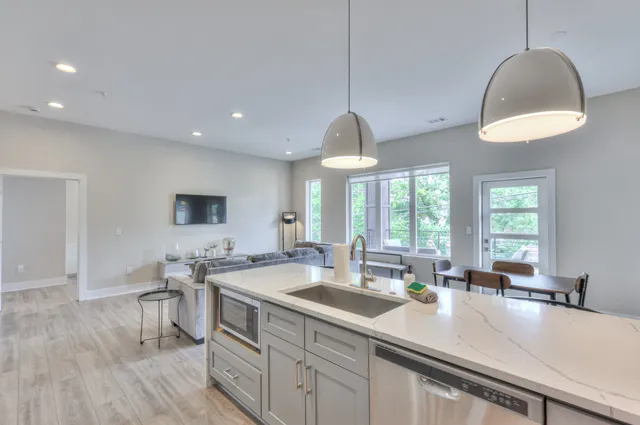a kitchen with lots of counter space a sink and a window