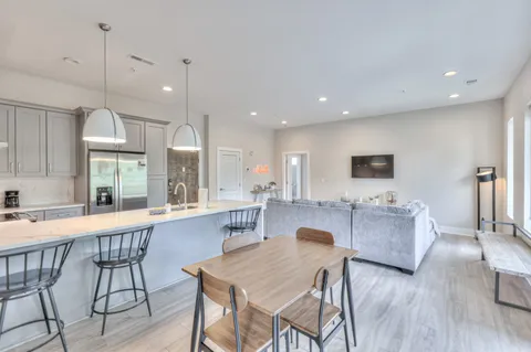 a large kitchen with a table and chairs