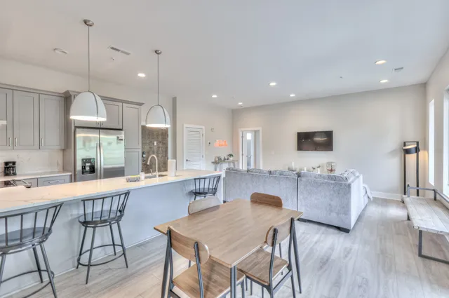 a large kitchen with a table and chairs