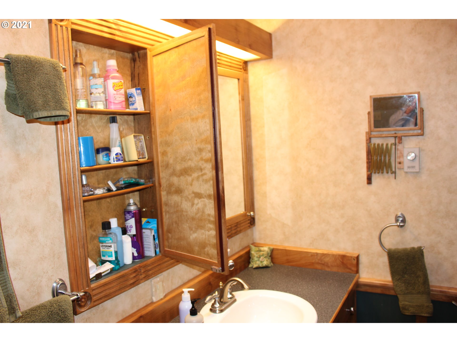 66069 North Bay Road North Bend, OR 97459 - Photo 25 of 32 a bathroom with a sink a mirror and a shower