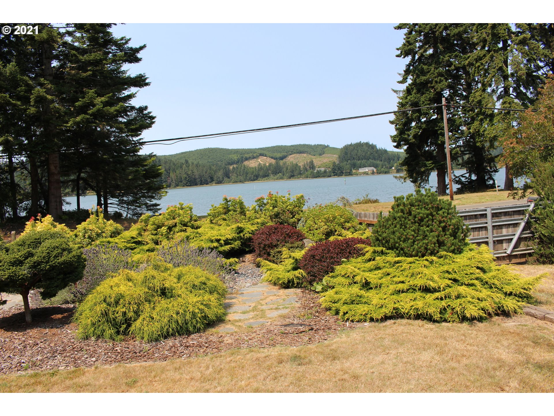 66069 North Bay Road North Bend, OR 97459 - Photo 4 of 32 a view of a lake with a house