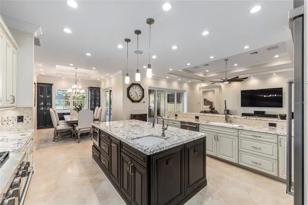 a spacious bedroom with a bed a window and ceiling fan