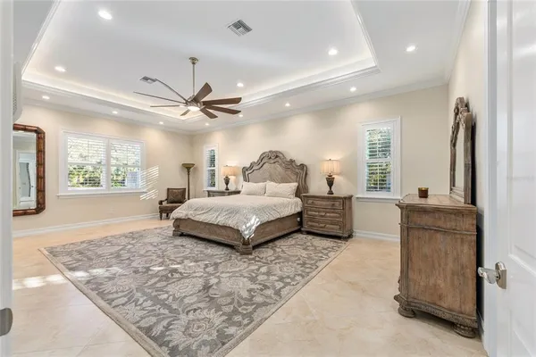 a spacious bathroom with a granite countertop double vanity and a mirror