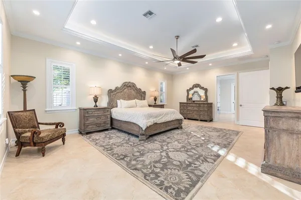 a bedroom with a bed and a lamp on a dresser