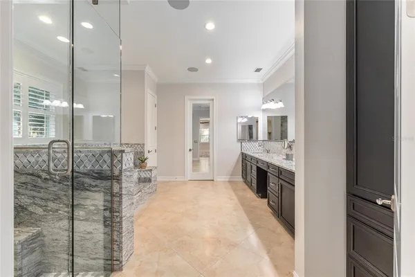 a bathroom with a granite countertop sink and a toilet