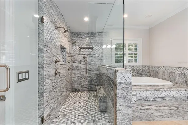 a bathroom with a tub and shower