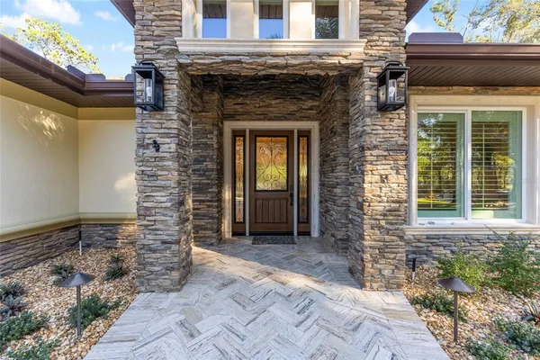 a front view of a house with a garden