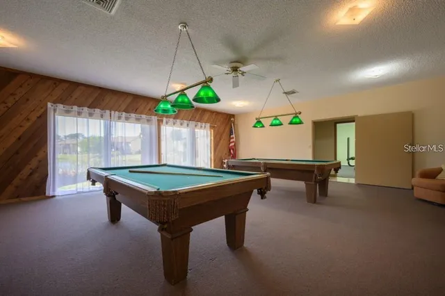 a room with furniture and pool table