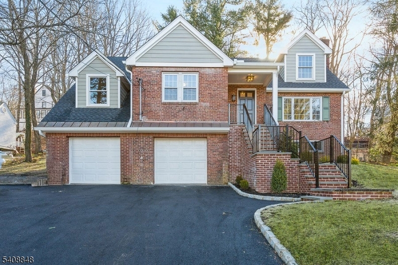 717 Fairmount Avenue Chatham, NJ 07928 - Photo 1 of 35 a front view of a house with a yard and garage