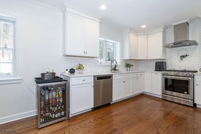 a kitchen with a stove window and cabinets