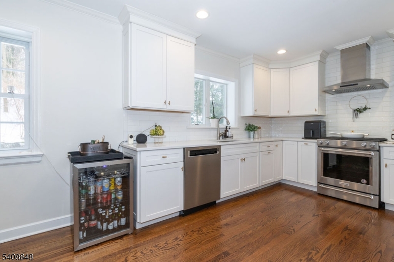 717 Fairmount Avenue Chatham, NJ 07928 - Photo 12 of 35 a kitchen with a stove window and cabinets