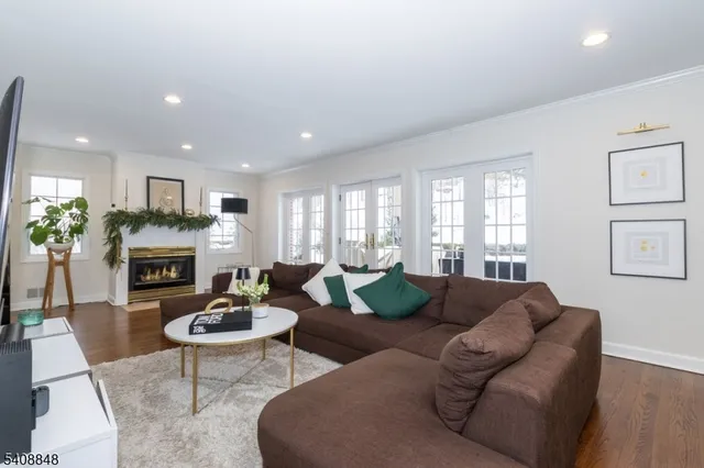 a living room with furniture a fireplace and a chandelier