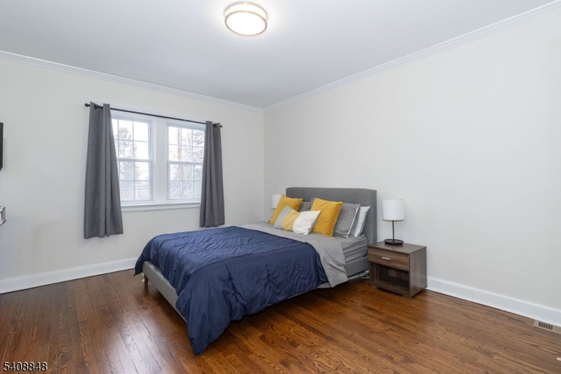 717 Fairmount Avenue Chatham, NJ 07928 - Photo 21 of 35 a bedroom with a bed and wooden floor
