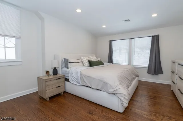 a bedroom with a bed and a large window