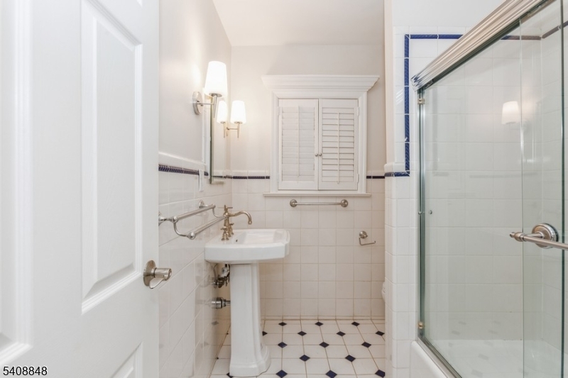 717 Fairmount Avenue Chatham, NJ 07928 - Photo 25 of 35 a bathroom with a sink a mirror and shower