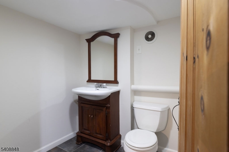 717 Fairmount Avenue Chatham, NJ 07928 - Photo 31 of 35 a bathroom with a toilet sink and mirror