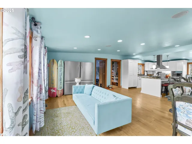 a living room with furniture and kitchen view