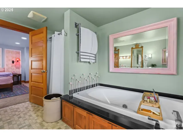 a bathroom with a sink mirror and a bathtub
