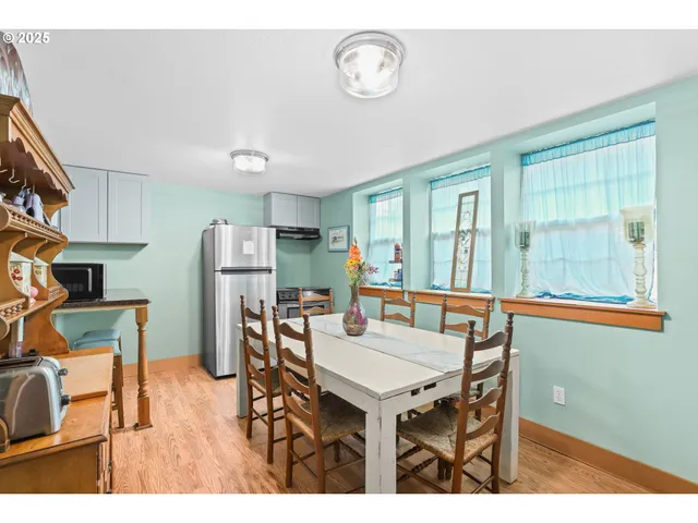 a view of a dining room with furniture and window