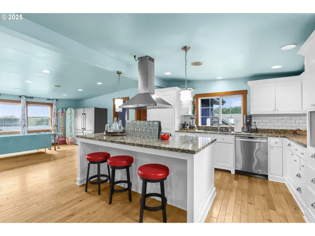 a kitchen with stainless steel appliances granite countertop a sink and cabinets