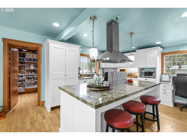 a kitchen with stainless steel appliances granite countertop a sink and a refrigerator