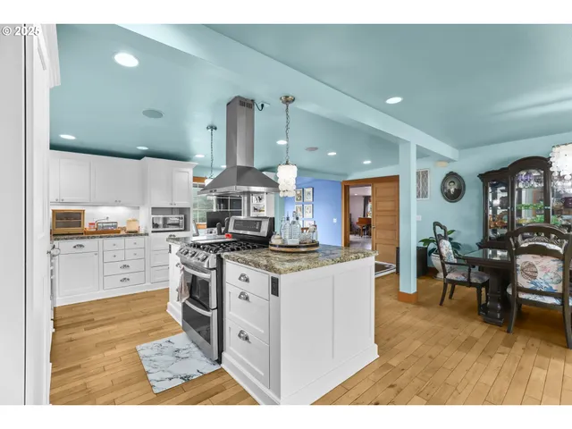 a open kitchen with stainless steel appliances kitchen island granite countertop a sink and cabinets